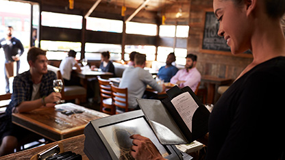 Smiling cashier at electronic till